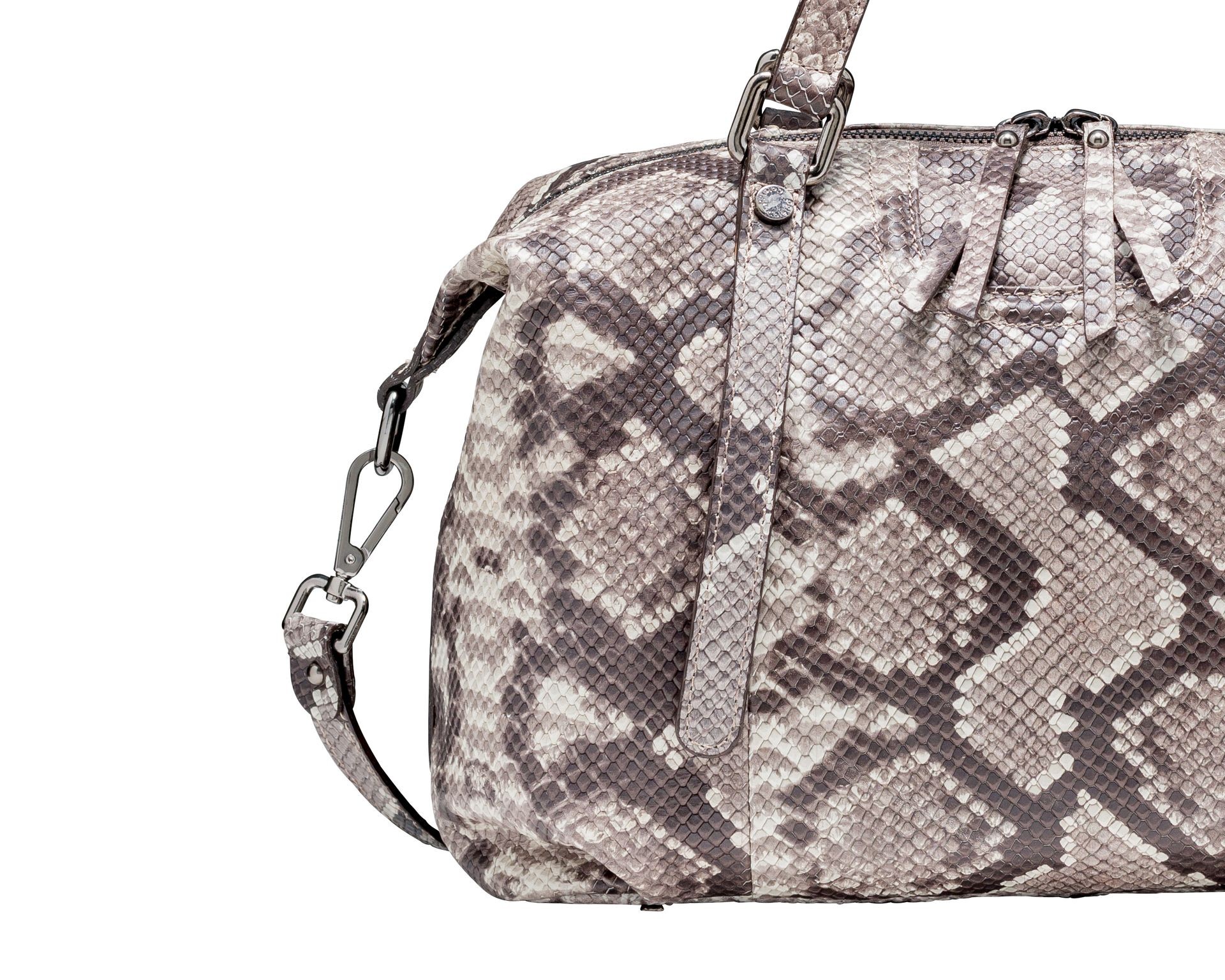 Close-up of a handbag with a snake skin pattern and an attached strap.